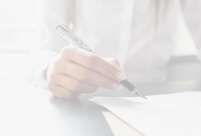 Male hand holding a fountain pen above documents